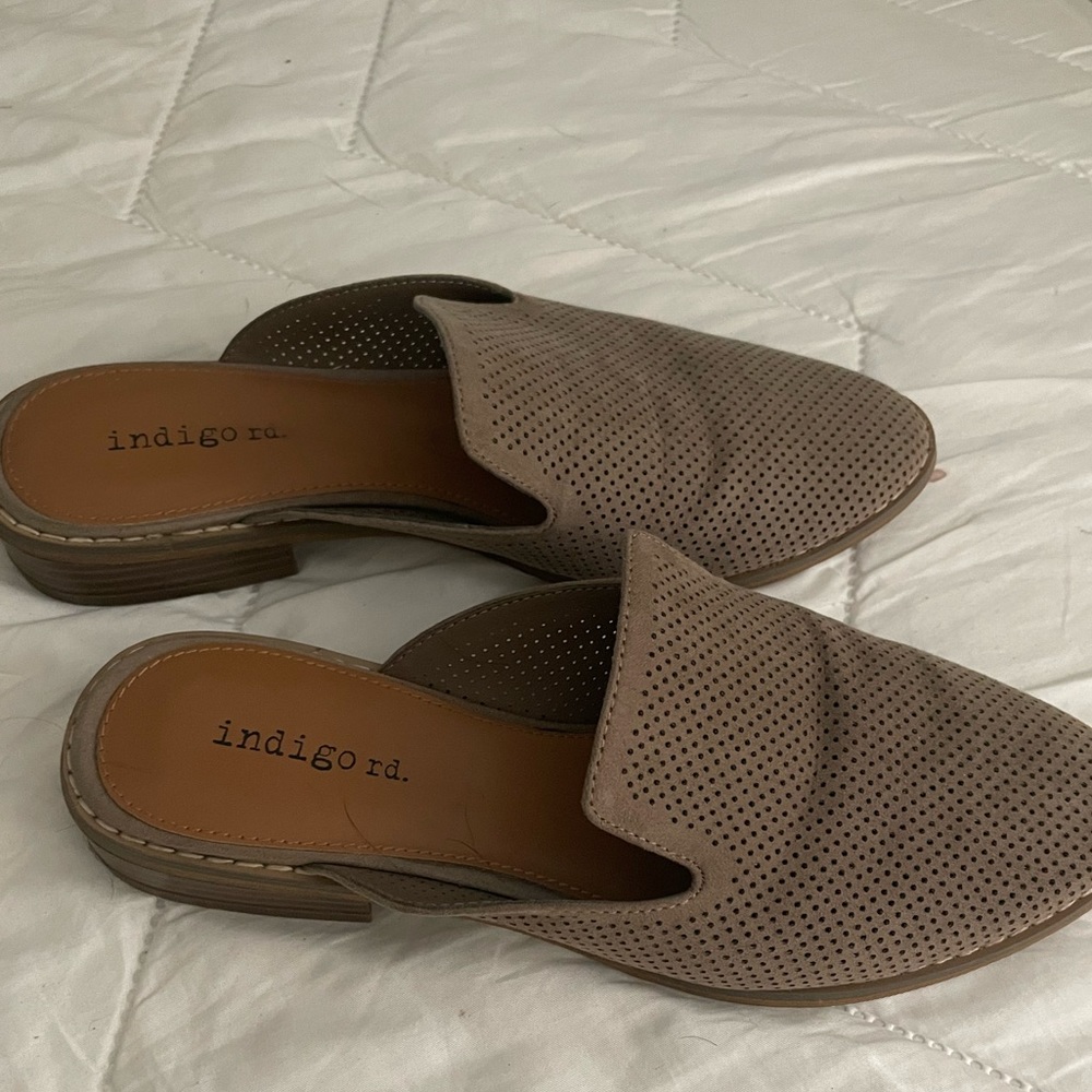 Neutral perforated mules, size 6.5